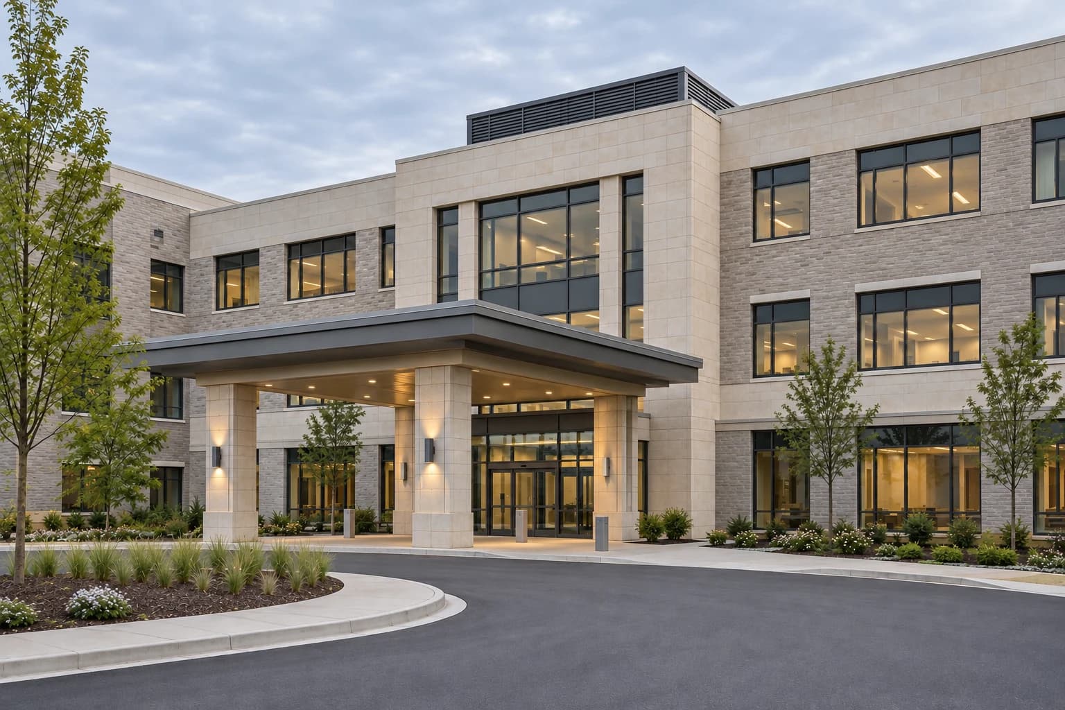 Illustrative healthcare building with pale masonry, a covered entrance and an empty landscaped approach