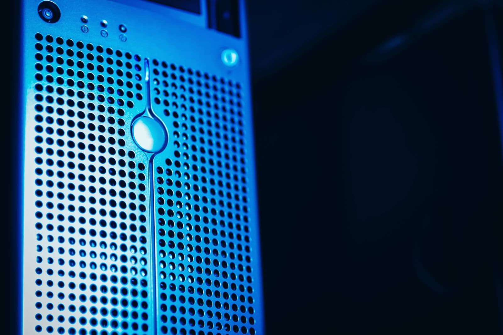 Rows of server racks in a blue-lit data hall.